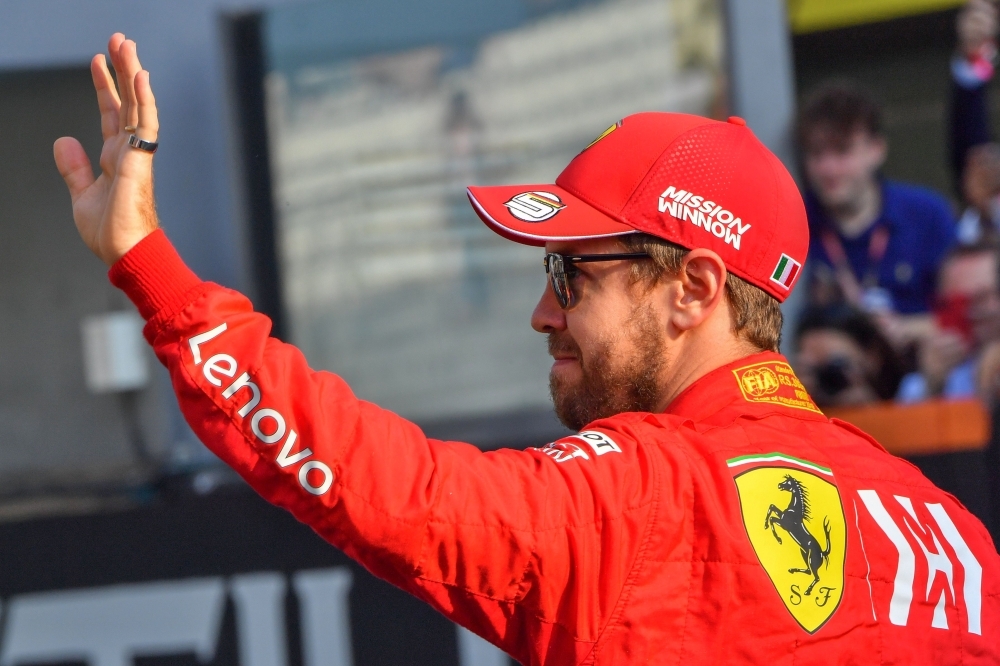 Ferrari's German driver Sebastian Vettel waves at the Yas Marina Circuit in Abu Dhabi, ahead of the final race of the season, on Sunday. — AFP
