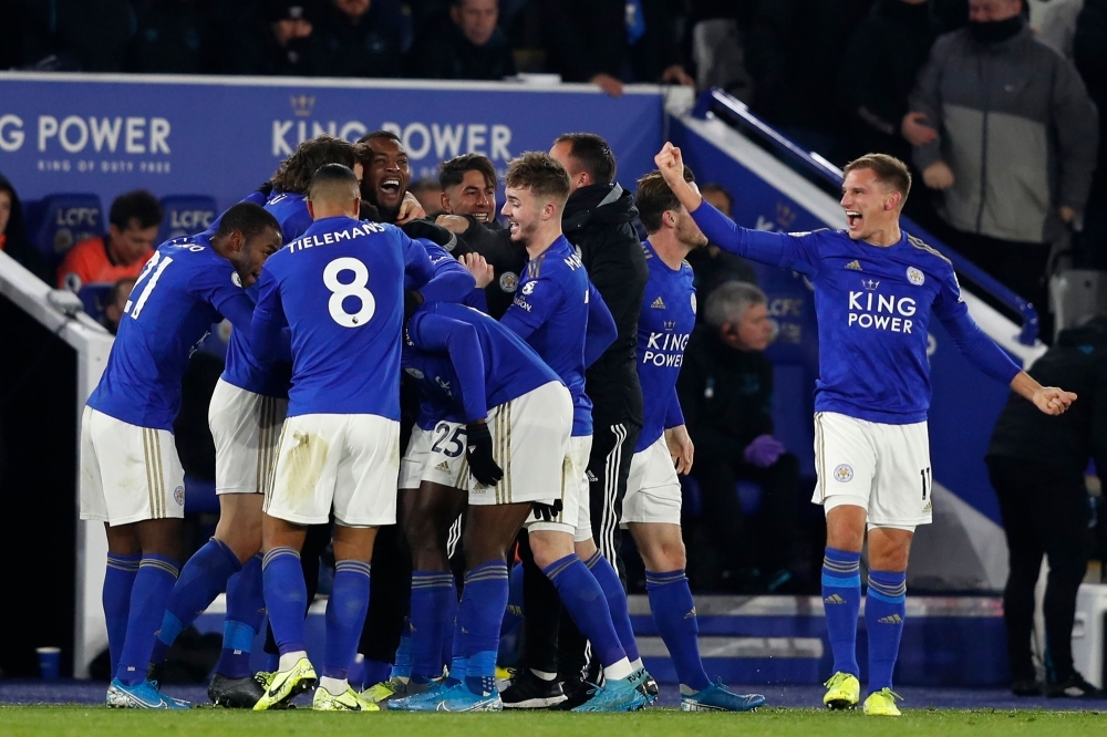 Leicester City's Nigerian striker Kelechi Iheanacho (R) shoots to score their late winning goal during the English Premier League football match between Leicester City and Everton at King Power Stadium in Leicester, central England, on Monday. Leicester won the game 2-1.— AFP