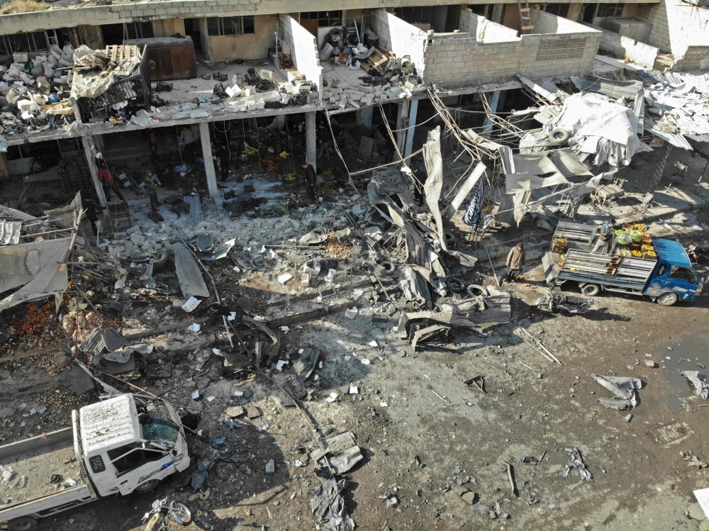 An aerial view shows the destruction following a regime air strike in a market in the town of Maaret Al-Numan in the militant-run Syrian province of Idlib on Monday. — AFP
