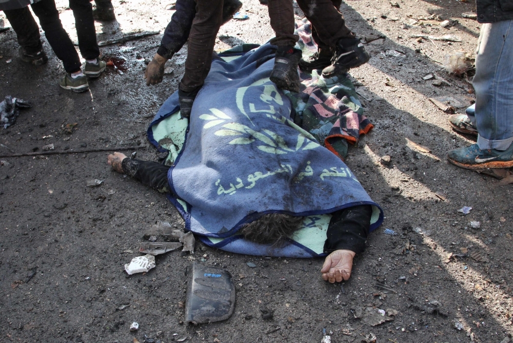 Bodies lie on the ground following a regime air strike in a market in the town of Maaret Al-Numan in the militant-run Syrian province of Idlib on Monday. — AFP