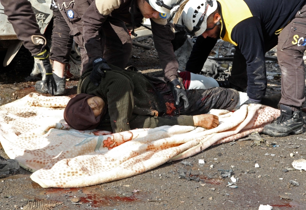 Bodies lie on the ground following a regime air strike in a market in the town of Maaret Al-Numan in the militant-run Syrian province of Idlib on Monday. — AFP