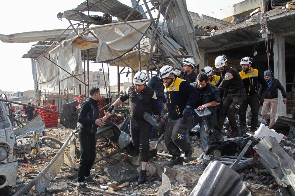 Bodies lie on the ground following a regime air strike in a market in the town of Maaret Al-Numan in the militant-run Syrian province of Idlib on Monday. — AFP