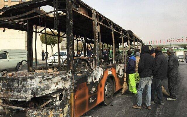 Iranians inspect the wreckage of a bus that was set ablaze by protesters during a demonstration against a rise in gasoline prices in the central city of Isfahan in this Nov. 17, 2019 file photo. — AFP
