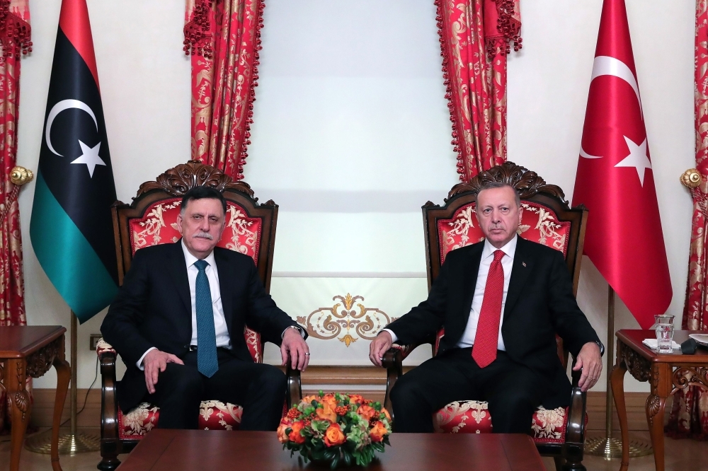 Turkish President Recep Tayyip Erdogan, right, and Fayez Al-Sarraj, the head of the Tripoli-based Government of National Accord (GNA) pose during their meeting in Istanbul in this Nov. 27, 2019 file photo. — AFP