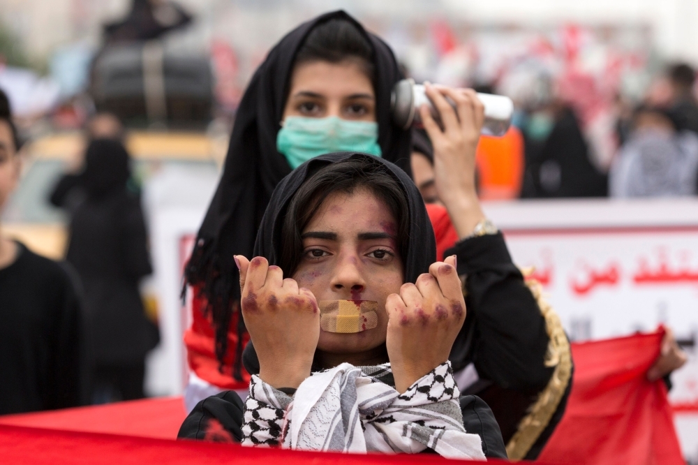 Iraqi mourners strike tambourines as they march in a funerary procession for an anti-government protester who died from injuries sustained in previous confrontations with security forces in the capital Baghdad on Tuesday. — AFP