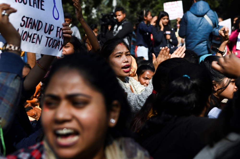 Social activists and supporters shout slogans to protest against the alleged rape and murder of a 27-year-old veterinary doctor in Hyderabad, during a demonstration in New Delhi, on Tuesday. — AFP