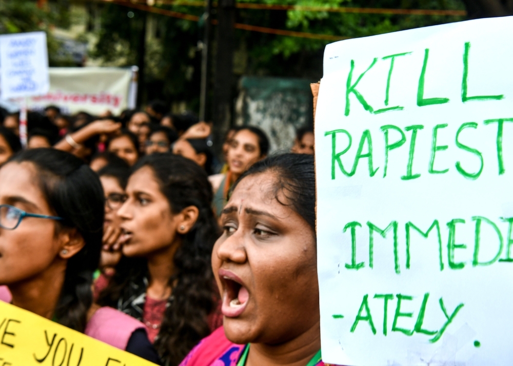 Social activists and supporters shout slogans to protest against the alleged rape and murder of a 27-year-old veterinary doctor in Hyderabad, during a demonstration in New Delhi, on Tuesday. — AFP