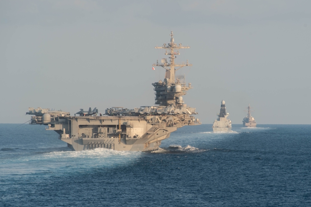 The aircraft carrier USS Abraham Lincoln, left, the air-defense destroyer HMS Defender, center, and the guided-missile destroyer USS Farragut transit the Strait of Hormuz in this Nov. 19, 2019 file photo. — AFP