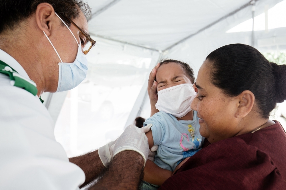 One-year-old Sanele receives her MMR vaccination at the Poutasi district hospital in the Samoan town of Poutasi on Wednesday. — AFP