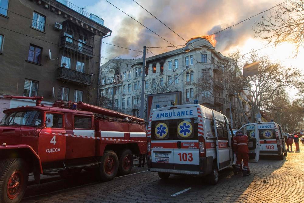 Firefighters extinguish a fire inside a college building in central Odessa, Ukraine, on Wednesday. — AFP
