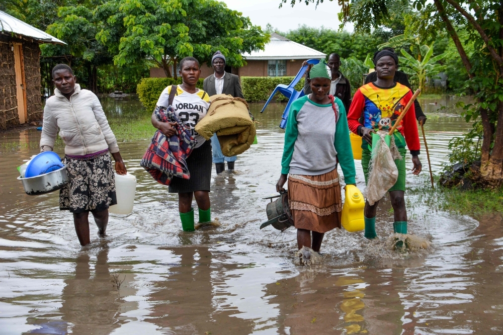 Displaced families flee to higher ground in K'akola village in Nyando sub-county in Kisumu after their houses were flooded in this Dec. 3, 2019 file photo. — AFP