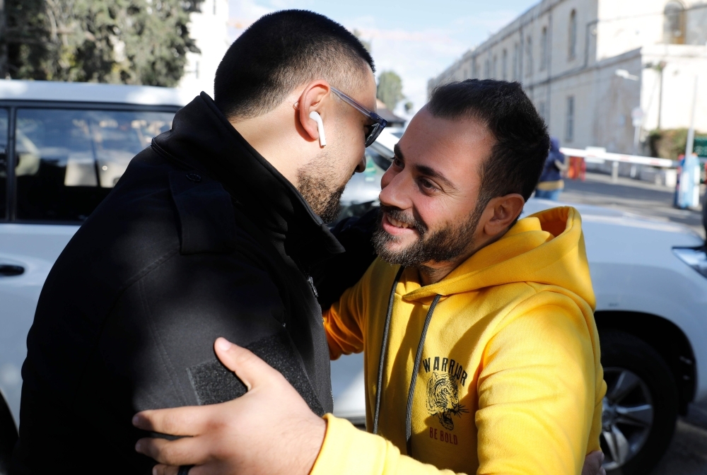 Palestinian journalists Dana Abou Shamsiyeh, left, Christine Renaoui second left, Ali Yassin, second right, and Amir Abed Rabbo, right, who were briefly detained by the Israeli authorities, is pictured upon their release in Jerusalem on Friday. — AFP