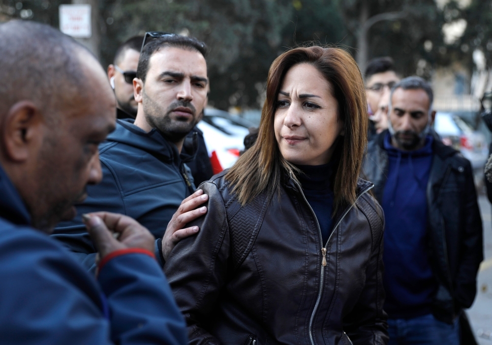 Palestinian journalists Dana Abou Shamsiyeh, left, Christine Renaoui second left, Ali Yassin, second right, and Amir Abed Rabbo, right, who were briefly detained by the Israeli authorities, is pictured upon their release in Jerusalem on Friday. — AFP