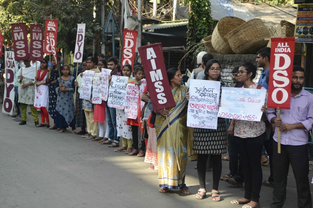 Indian youths and students hold placards against the recent rapes throughout the country during a demonstration in Siliguri on Saturday. -AFP
