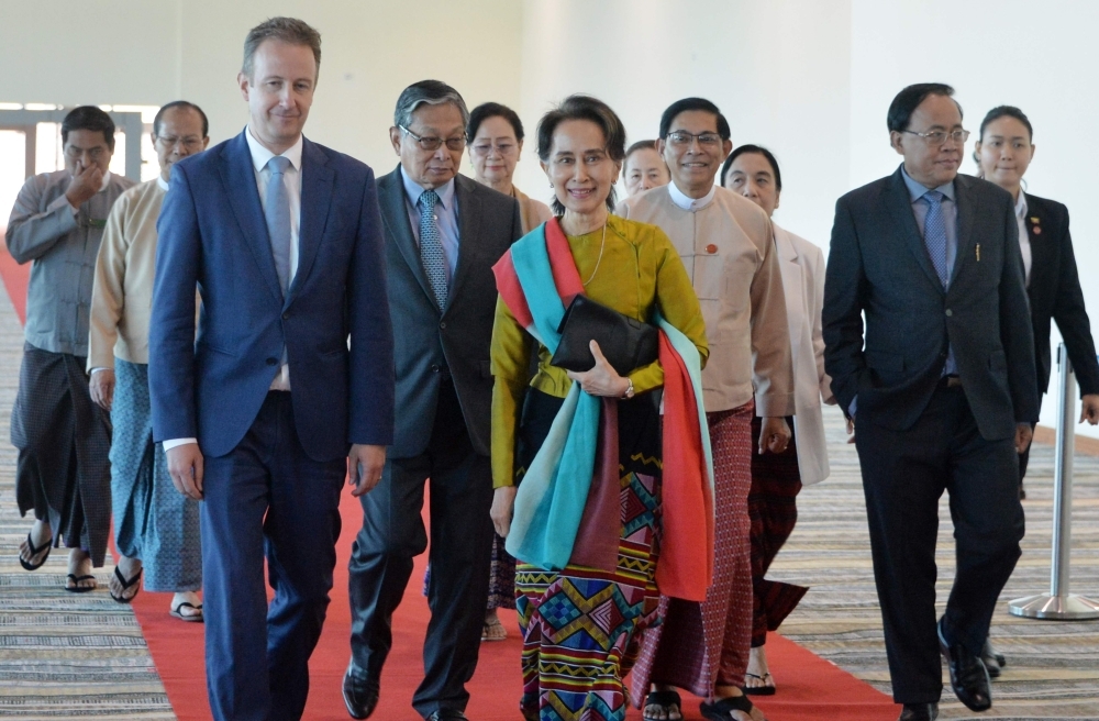 Myanmar State Counsellor Aung San Suu Kyi (C) leaves from Naypyitaw International Airport in Naypyidaw on Sunday, ahead of her appearance at the International Court of Justice in The Hague to defend the country against charges. -AFP