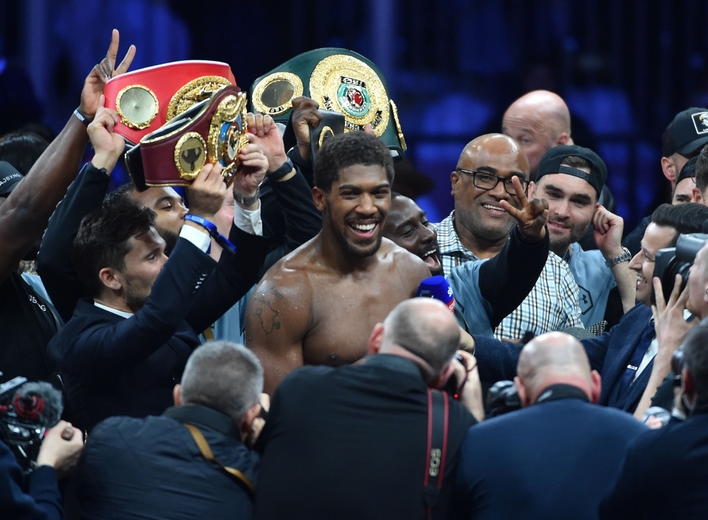 British boxer Anthony Joshua celebrates after winning the heavyweight boxing match between Andy Ruiz Jr. and Anthony Joshua for the IBF, WBA, WBO and IBO titles in Diriyah, near the Saudi capital Riyadh, on Saturday. Joshua reclaimed his world heavyweight crown from Andy Ruiz, outclassing the Mexican-American to score a unanimous points victory. — AFP