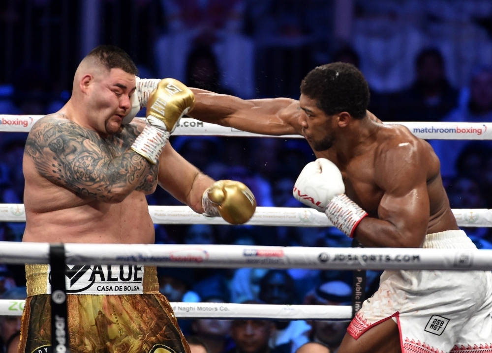 British boxer Anthony Joshua celebrates after winning the heavyweight boxing match between Andy Ruiz Jr. and Anthony Joshua for the IBF, WBA, WBO and IBO titles in Diriyah, near the Saudi capital Riyadh, on Saturday. Joshua reclaimed his world heavyweight crown from Andy Ruiz, outclassing the Mexican-American to score a unanimous points victory. — AFP