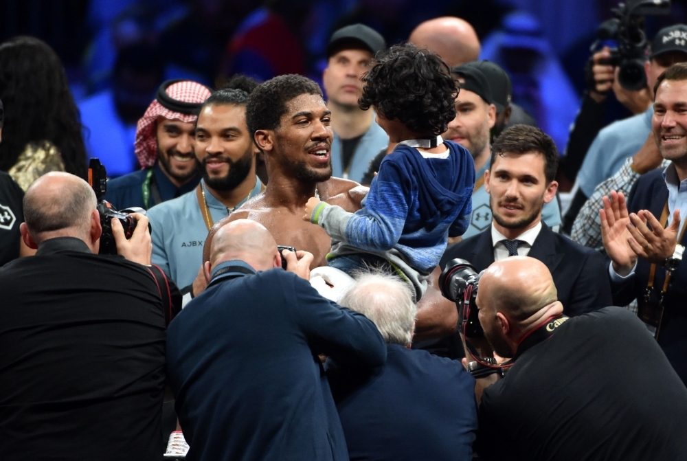 British boxer Anthony Joshua celebrates after winning the heavyweight boxing match between Andy Ruiz Jr. and Anthony Joshua for the IBF, WBA, WBO and IBO titles in Diriyah, near the Saudi capital Riyadh, on Saturday. Joshua reclaimed his world heavyweight crown from Andy Ruiz, outclassing the Mexican-American to score a unanimous points victory. — AFP