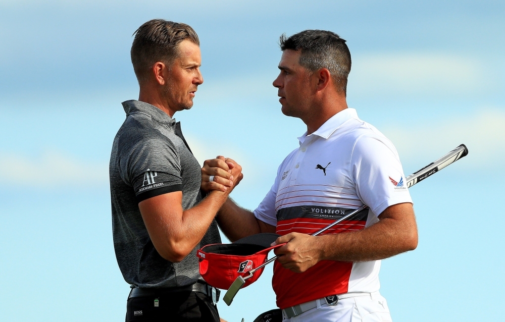 Henrik Stenson of Sweden shakes hands with Gary Woodland of the United States after winning the Hero World Challenge at Albany in Nassau, Bahamas, on Saturday. — AFP