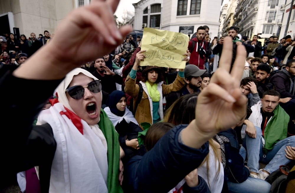 Algerian students shout slogans during an anti-government demonstration in the capital Algiers on Monday ahead of the presidential vote scheduled for Dec. 12. — AFP