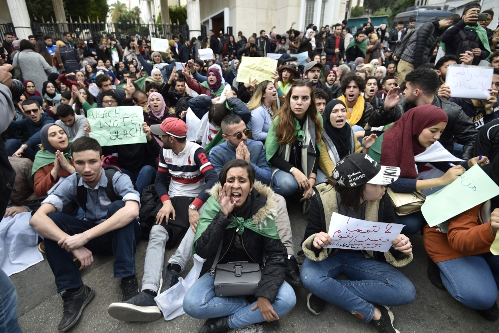 Algerian students shout slogans during an anti-government demonstration in the capital Algiers on Monday ahead of the presidential vote scheduled for Dec. 12. — AFP