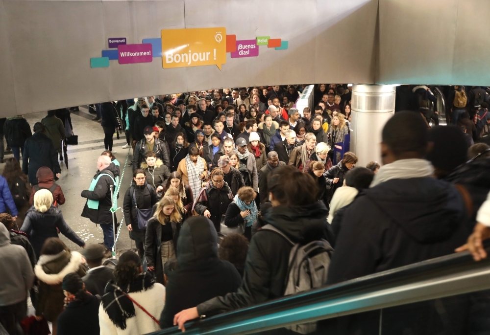 Commuters walk at Saint-Lazare metro station in Paris on Monday during a strike of Paris public transports operator RATP employees over French government's plan to overhaul the country's retirement system, as part of a national strike. — AFP