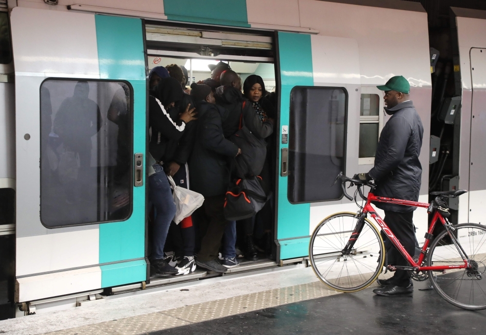 Commuters walk at Saint-Lazare metro station in Paris on Monday during a strike of Paris public transports operator RATP employees over French government's plan to overhaul the country's retirement system, as part of a national strike. — AFP