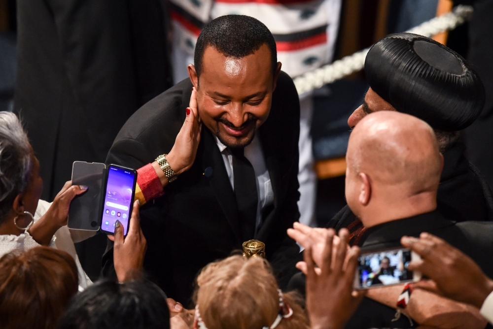 Ethiopia's Prime Minister and Nobel Peace Prize Laureate Abiy Ahmed Ali is greeted by well wishers after receiving the Nobel Peace Prize during a ceremony at the city hall in Oslo on Tuesday. — AFP