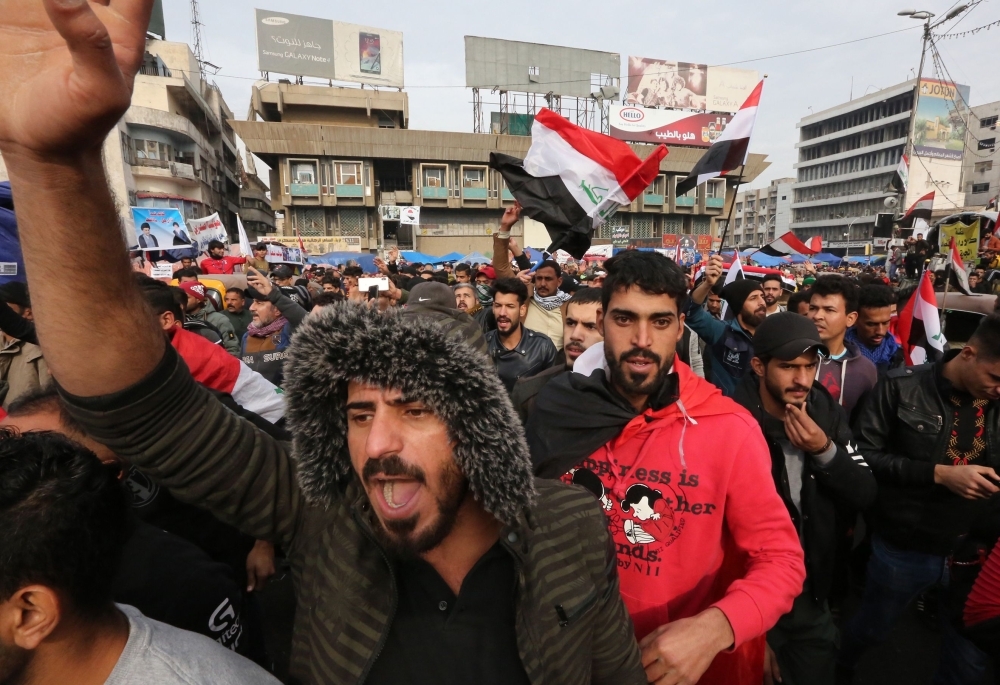 An Iraqi demonstrator wears a Guy Fawkes mask at Tahrir square in the capital Baghdad amid ongoing anti-government protests on Tuesday. — AFP