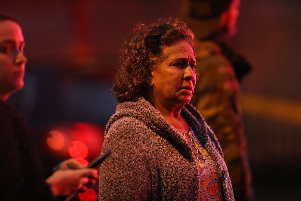 Residents are kept back as emergency personnel work the scene of a shooting that left multiple people dead in Jersey City, New Jersey, on Tuesday. — AFP