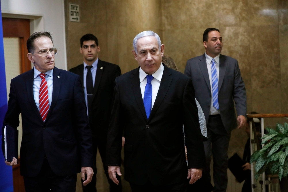 Israeli Prime Minister Benjamin Netanyahu, center, arrives at the weekly Cabinet meeting in Jerusalem in this Dec. 8, 2019 file photo. — AFP