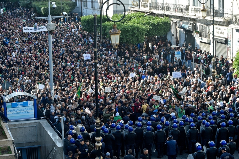 Algerian security forces surround protesters during an anti-government demonstration in the capital Algiers on Wednesday. — AFP