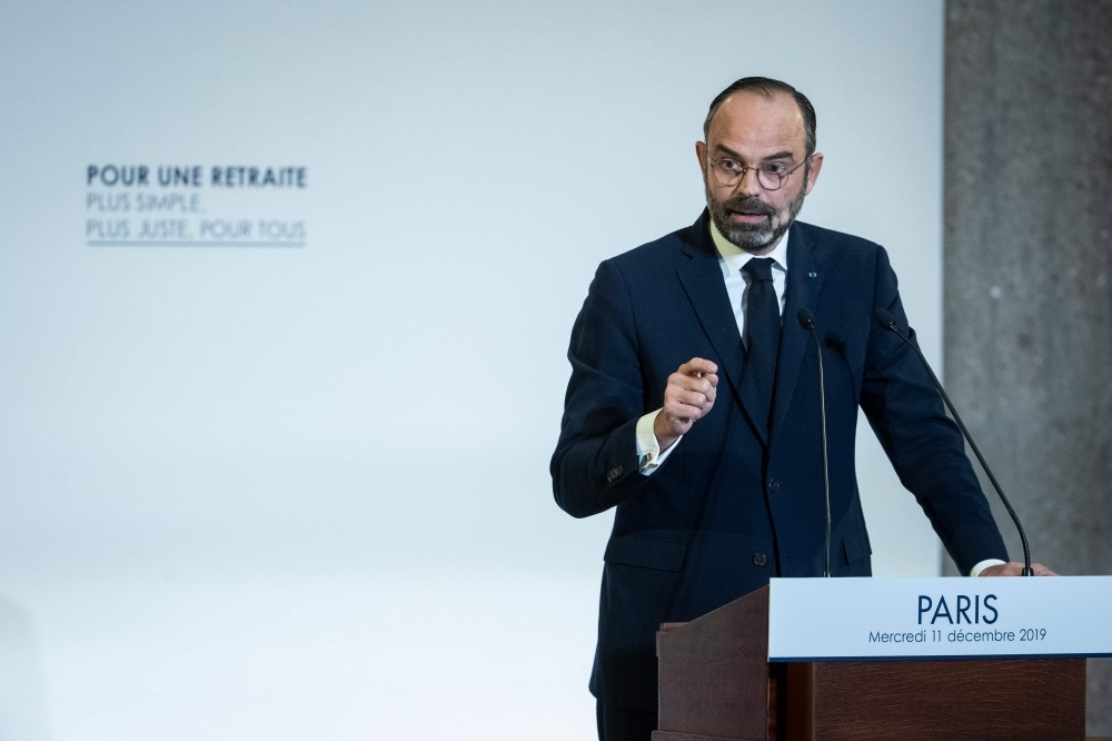 French Prime Minister Edouard Philippe unveils the details of a pension reform plan before the CESE (Economic, Social and Environmental Council) on Tuesday in Paris, as hundreds of thousands of people demonstrated the day before on the sixth day of a general strike.  — AFP