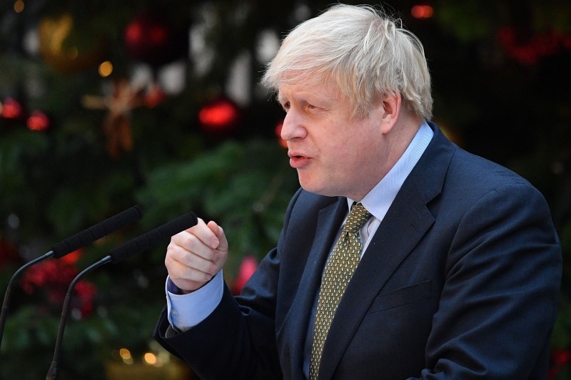 Britain's Prime Minister Boris Johnson delivers a speech outside 10 Downing Street in central London on Friday. -AFP