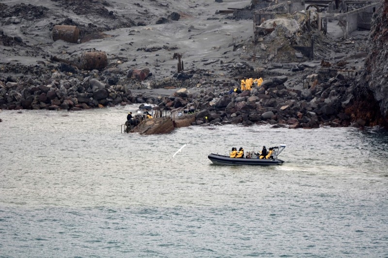 This handout photo taken and released on December 13, 2019 by the New Zealand Defence Force shows elite soldiers taking part in a mission to retrieve bodies from White Island after the December 9 volcanic eruption, off the coast from Whakatane on the North Island. -AFP