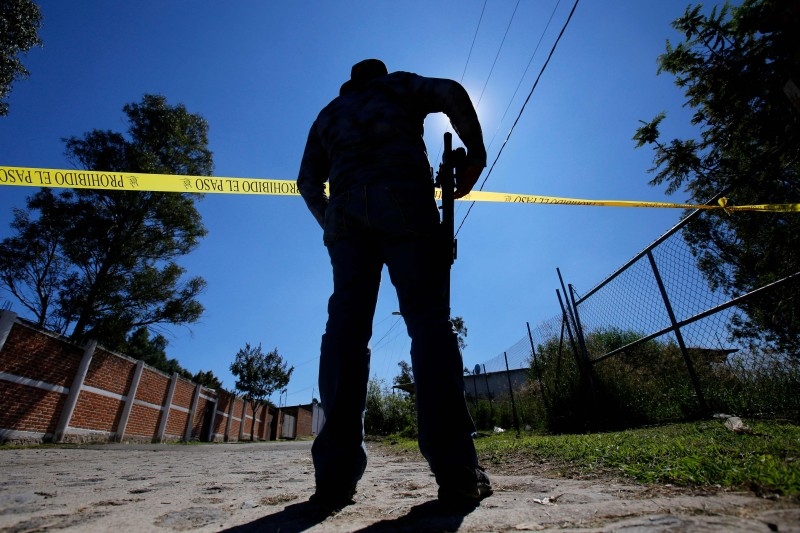 A staff member of the Specialized Prosecutor's Office for Missing Persons works at El Mirador neighborhood, in Tlajomulco de Zuniga, state of Jalisco, Mexico, on November 22, 2019.  Mexico's Prosecutor's Office said on Saturday, after 23 days of work, that the remains of at least 50 people were found in a clandestine common grave in Tlajomulco de Zuniga. -AFP
