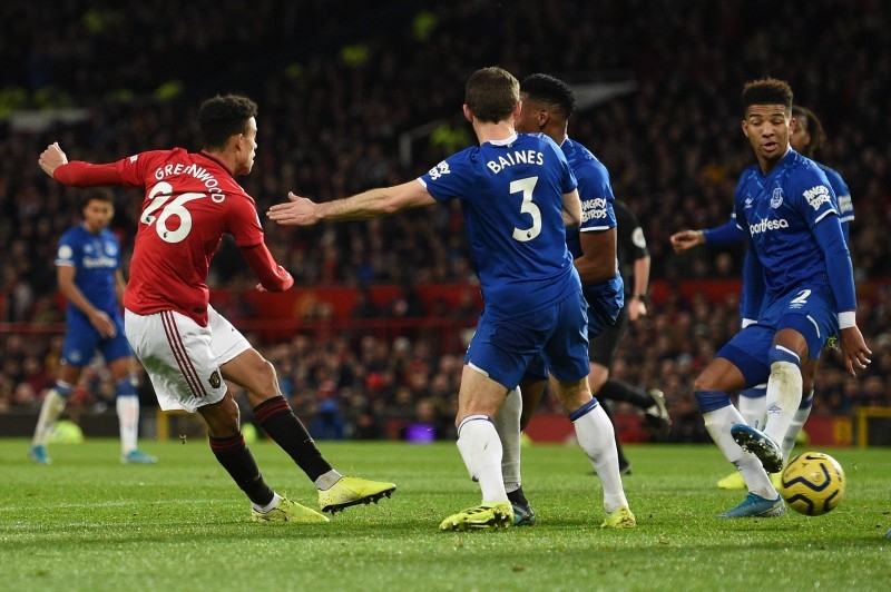 Manchester United's English striker Mason Greenwood (L) scores their first goal to equalize 1-1 during the English Premier League football match against Everton at Old Trafford in Manchester, north west England, on Sunday. — AFP