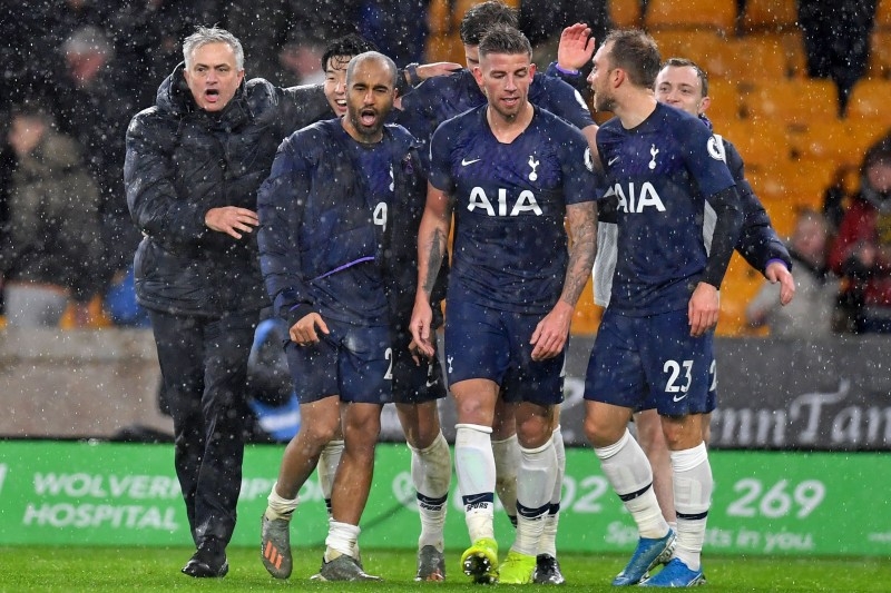 Tottenham Hotspur's Portuguese head coach Jose Mourinho (L) celebrates with his players on the pitch after the English Premier League football match against Wolverhampton Wanderers at the Molineux stadium in Wolverhampton, central England on Sunday. — AFP