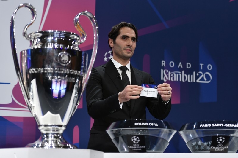 UEFA Champions League's ambassador Hamit Altintop holds the slip of FC Barcelona during the UEFA Champions League football cup round of 16 draw ceremony on Monday in Nyon.  — AFP 