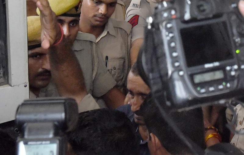 Kuldeep Singh Sengar, center, a politician who has been accused of rape in a high profile case in Uttar Pradesh state, comes out of the court to be moved to Tihar Jail in New Delhi in this Aug. 5, 2019 file photo. — AFP