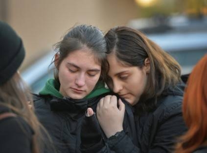 Two young girls mourn at a memorial outside the nightclub Colectiv in Bucharest in this file photo. — AFP