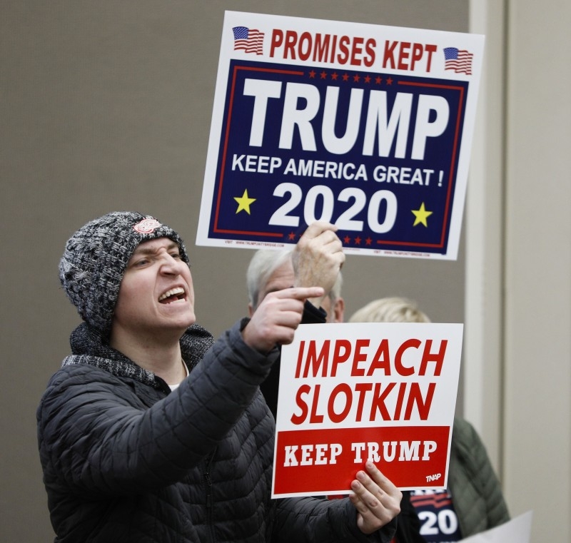 A protester shouts at US Congresswoman Elissa Slotkin at a Town Hall meeting where she was discussing her decision to vote in favor of the impeachment of President Donald Trump to her constituents in Rochester, Michigan, on Monday. — AFP
