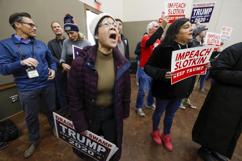 A protester shouts at US Congresswoman Elissa Slotkin at a Town Hall meeting where she was discussing her decision to vote in favor of the impeachment of President Donald Trump to her constituents in Rochester, Michigan, on Monday. — AFP