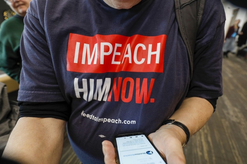 A protester shouts at US Congresswoman Elissa Slotkin at a Town Hall meeting where she was discussing her decision to vote in favor of the impeachment of President Donald Trump to her constituents in Rochester, Michigan, on Monday. — AFP