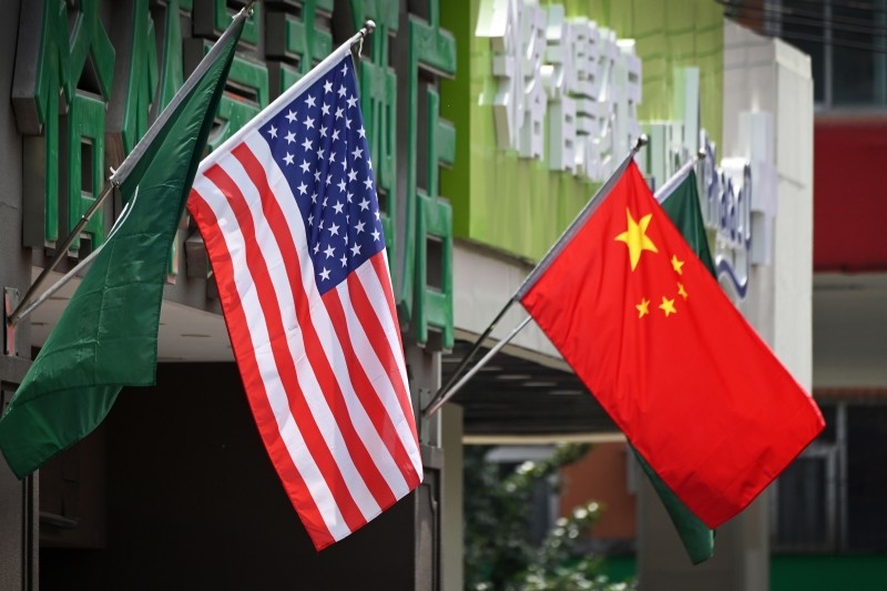 This file photo taken on May 14, 2019 shows the US, left and Chinese flags displayed outside a hotel in Beijing. — AFP