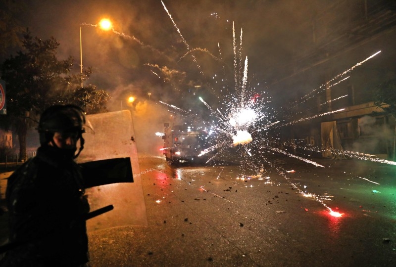 Protesters set aflame dumpsters and tires as they block a road in the southern Lebanese city of Sidon early on Tuesday. — AFP