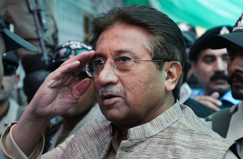Pervez Musharraf is escorted by soldiers as he salutes on his arrival at an anti-terrorism court in Islamabad in this file photo. 