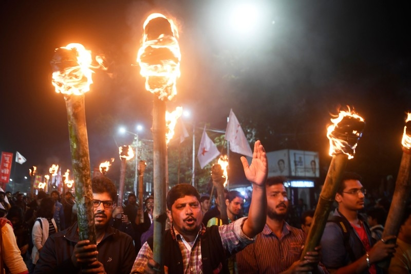 Members of various leftist student groups take part in a torch rally to protest against India's new citizenship law in Kolkata on Tuesday. — AFP