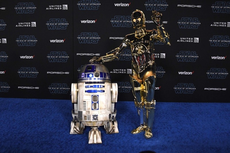 R2-D2, left, and C-3PO arrive for the world premiere of Disney's 