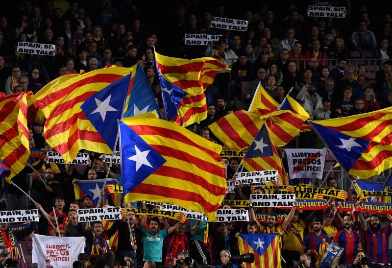 Barcelona's supporters hold placards reading 